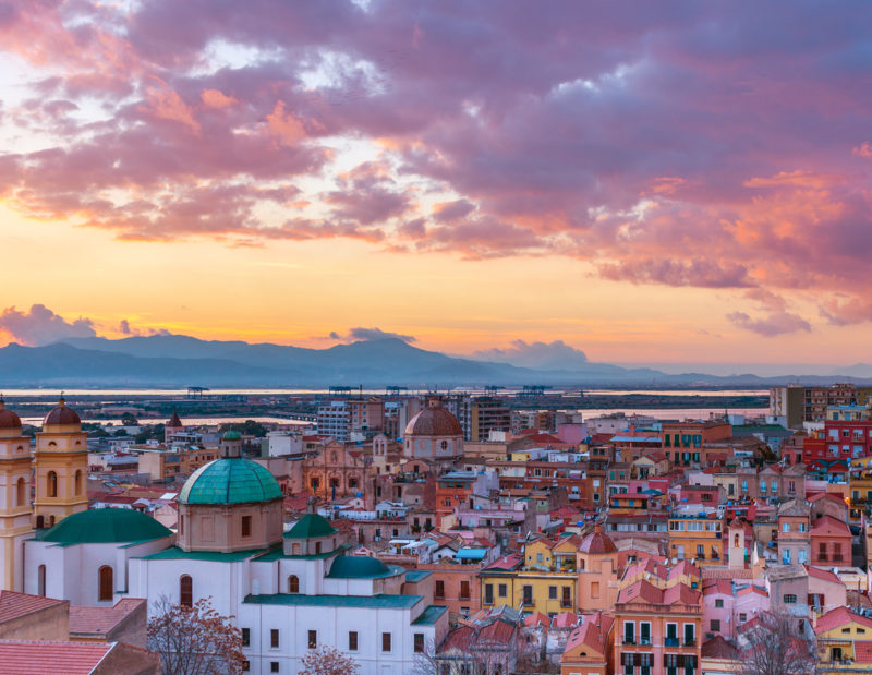 Sunset on Cagliari, evening panorama of the old city center in Sardinia Capital, view on The Old Cathedral and colored houses in traditional style, Italy.
